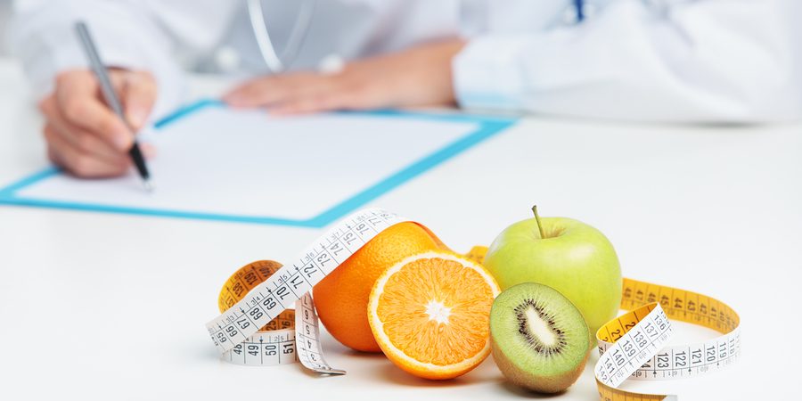 Nutritionist Doctor Nutritionist Doctor is writing a prescription. Focus on fruit
** Note: Shallow depth of field
