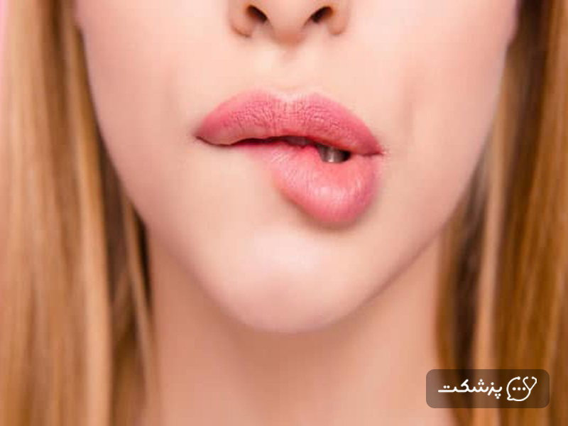 یک زن در حال گاز گرفتن لب های خود
